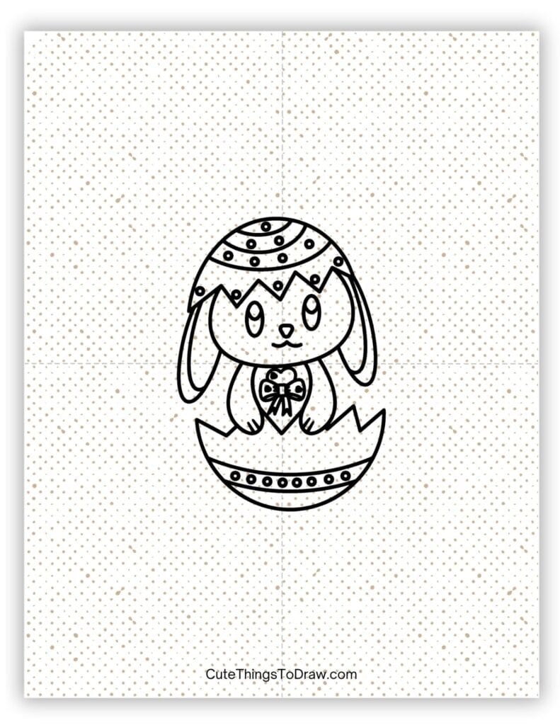 Easter rabbit sitting in a decorated egg to draw
